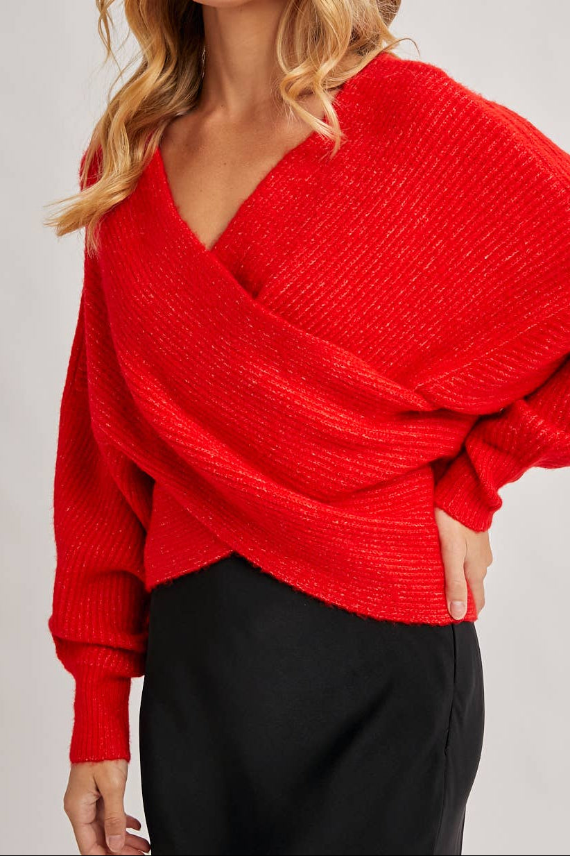 Woman wearing a red sweater against a plain background