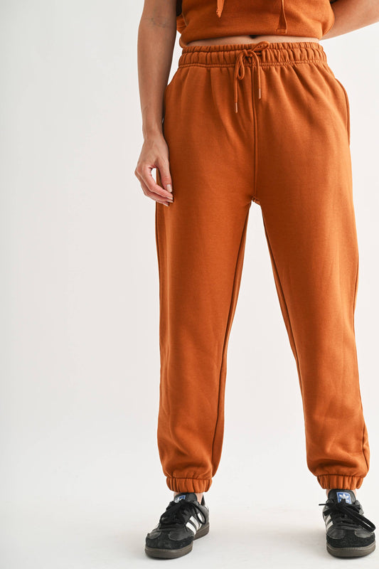 Orange comfy fleece billow sweatpants with a drawstring waist