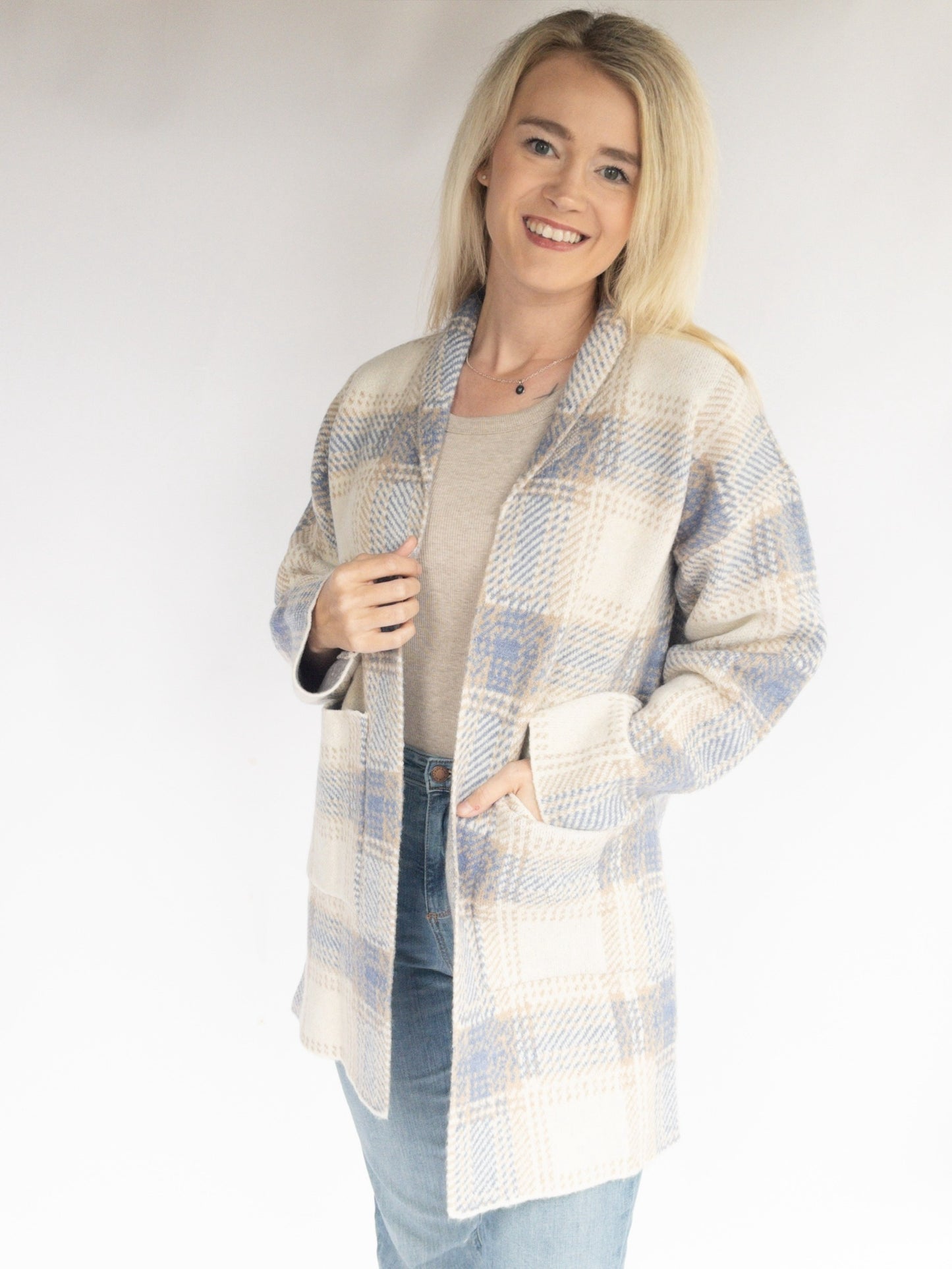 Cozy Checker Sweater long Cardigan with plaid detailing over a beige tank top with judy blue high rise jeans