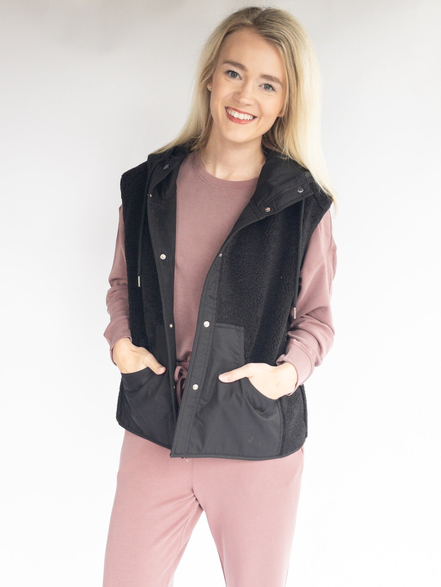 Black sherpa hoodie vest with pockets and suede on the inside