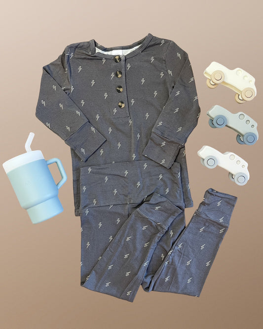 Lou Lou & Company Everett set with lighting bolts, accompanied by a blue tumbler and toy cars.